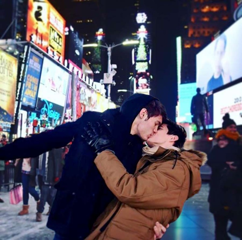 Non-binary strangers enjoy an impromptu consensual kiss in Times Square to celebrate the Triumph of the Stonewall Riot.