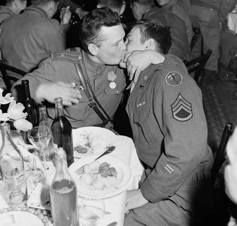 Gay Russian junior lieutenant coaxes a shy American staff sergeant out of the closet with a celebratory tongue wrestle after the defeat of the White Supremacist Nazi German forebears of future Trump supporters and MAGA.