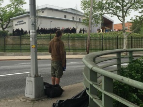 HomelessGuyWatchingCollegeGradsResized.jpg